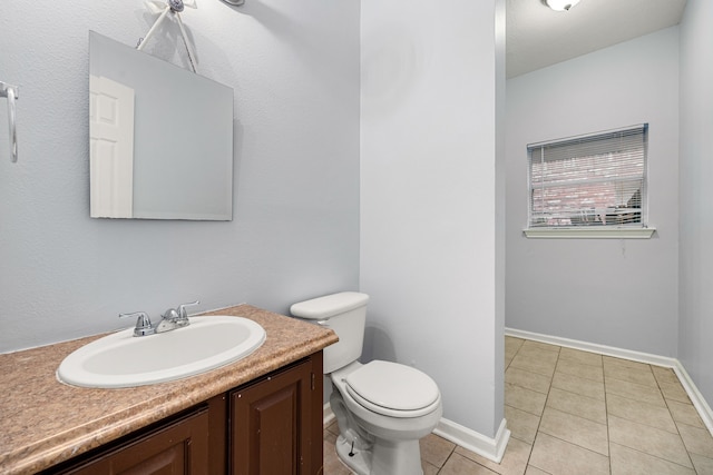 bathroom with tile patterned flooring, vanity, and toilet