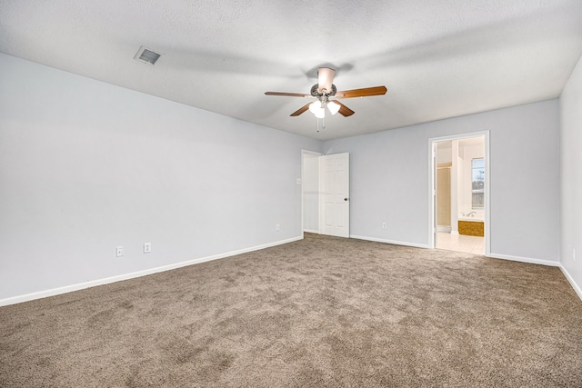 carpeted empty room with a textured ceiling and ceiling fan