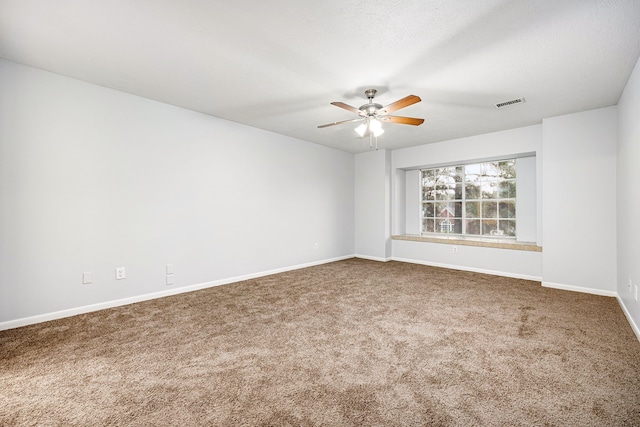 empty room with ceiling fan and carpet floors