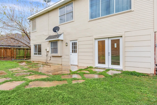 back of house featuring a yard and a patio