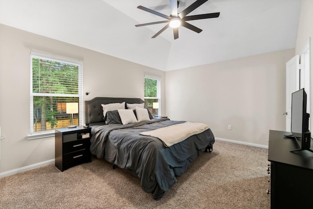 bedroom featuring ceiling fan, multiple windows, light carpet, and vaulted ceiling