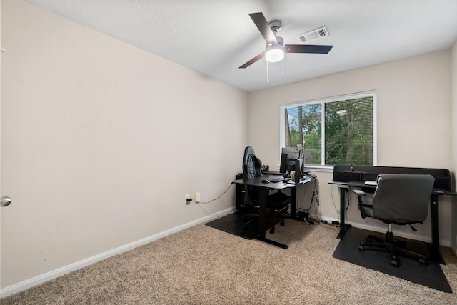 carpeted home office with ceiling fan