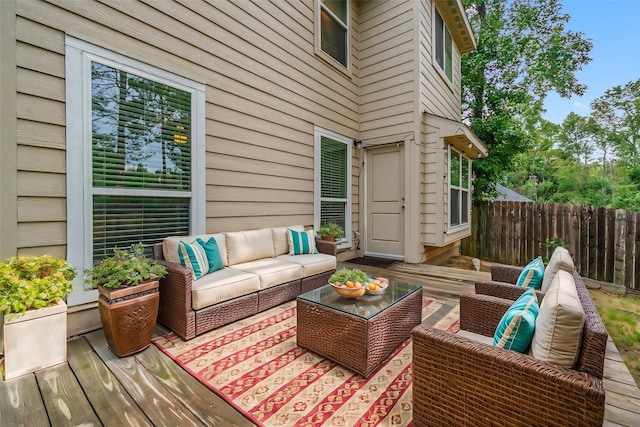 wooden terrace with an outdoor living space