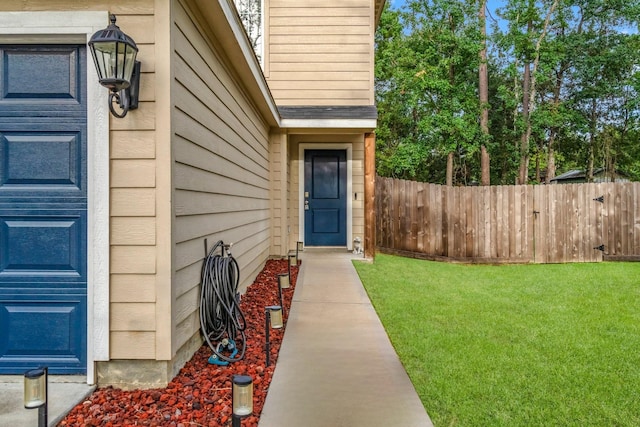 doorway to property with a yard