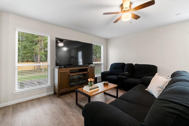 living room featuring ceiling fan and light hardwood / wood-style floors