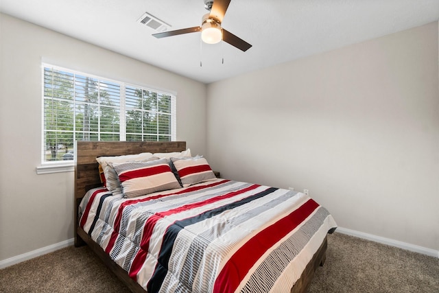 bedroom featuring ceiling fan and dark carpet