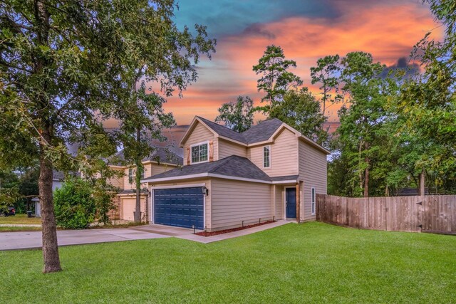 view of front of property featuring a yard and a garage