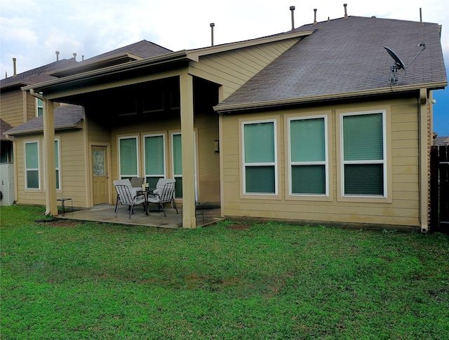 back of house featuring a patio area and a yard