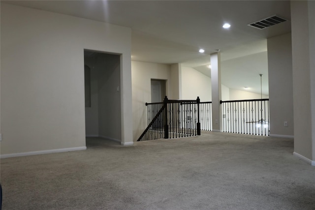 empty room featuring carpet floors and lofted ceiling