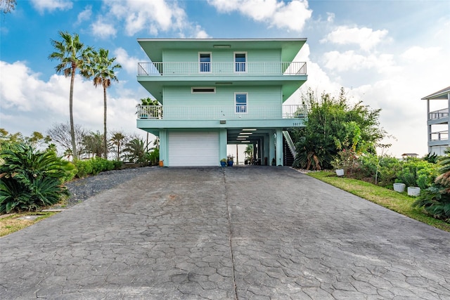 view of front of home with a garage and a carport