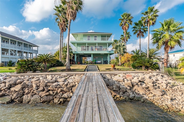 back of property featuring a water view