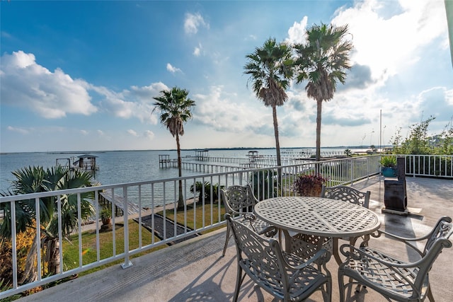 view of patio featuring a water view and a boat dock