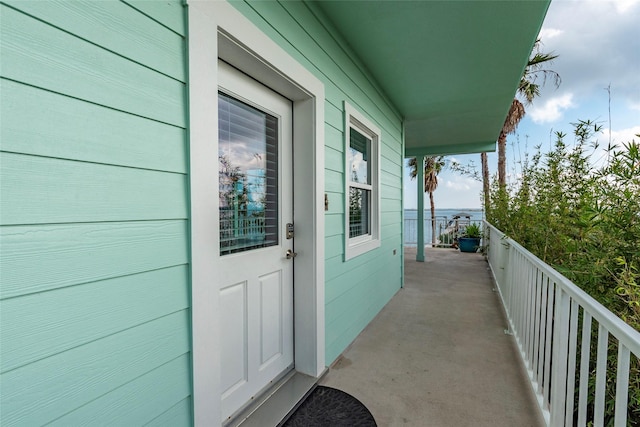 view of exterior entry with a balcony