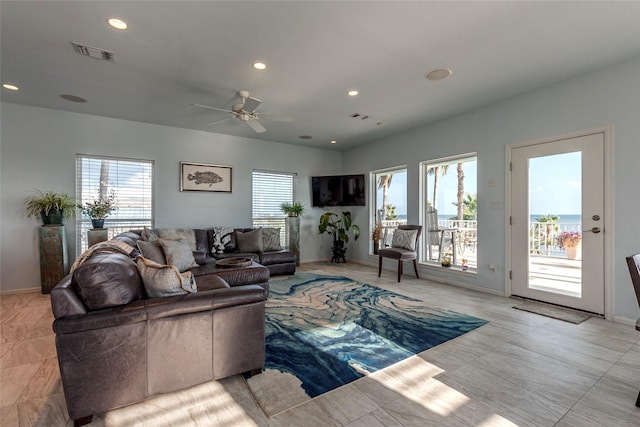 living area featuring a ceiling fan, recessed lighting, baseboards, and visible vents