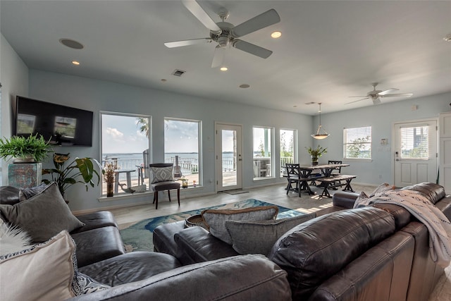 living area featuring ceiling fan, visible vents, recessed lighting, and a wealth of natural light