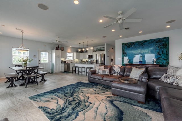 living area with visible vents, ceiling fan, and recessed lighting