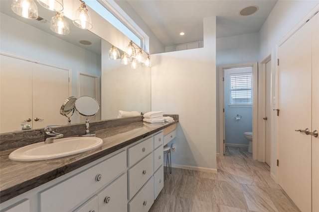 bathroom with vanity and toilet