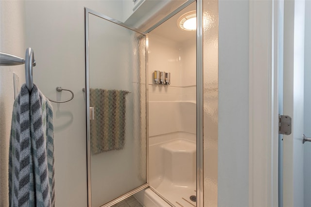 bathroom with a shower with shower door