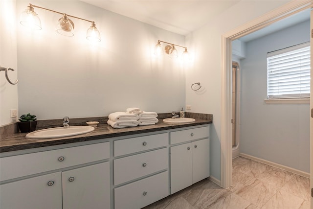 bathroom with vanity and a shower with shower door