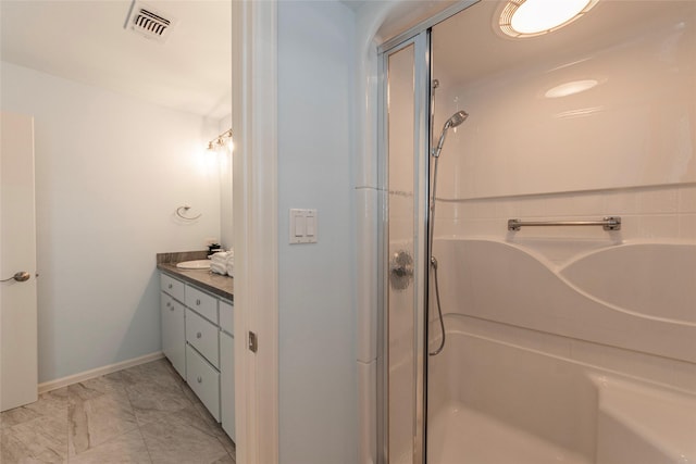 bathroom with vanity and a shower with door