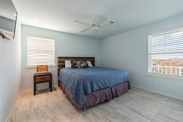 bedroom featuring multiple windows and ceiling fan