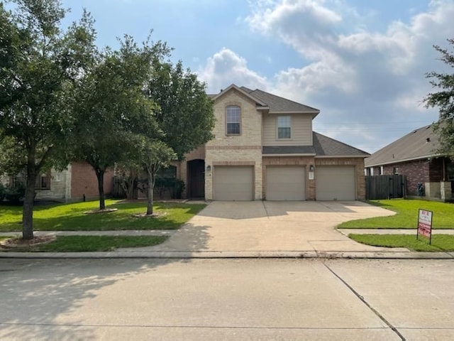 view of front of property with a garage and a front lawn