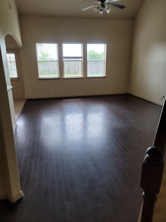 spare room featuring ceiling fan and dark wood-type flooring