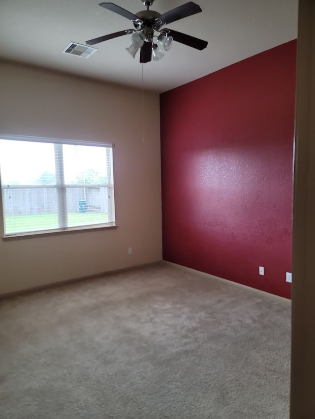 carpeted empty room featuring ceiling fan