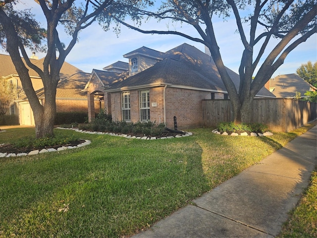 view of side of home featuring a yard and a storage shed