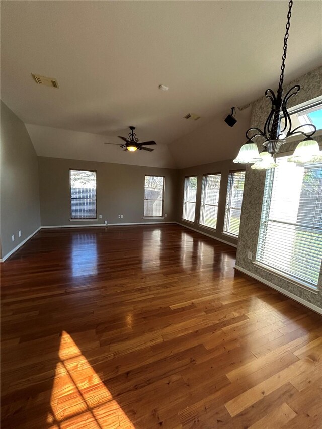 interior space with hardwood / wood-style flooring, lofted ceiling, and ceiling fan with notable chandelier