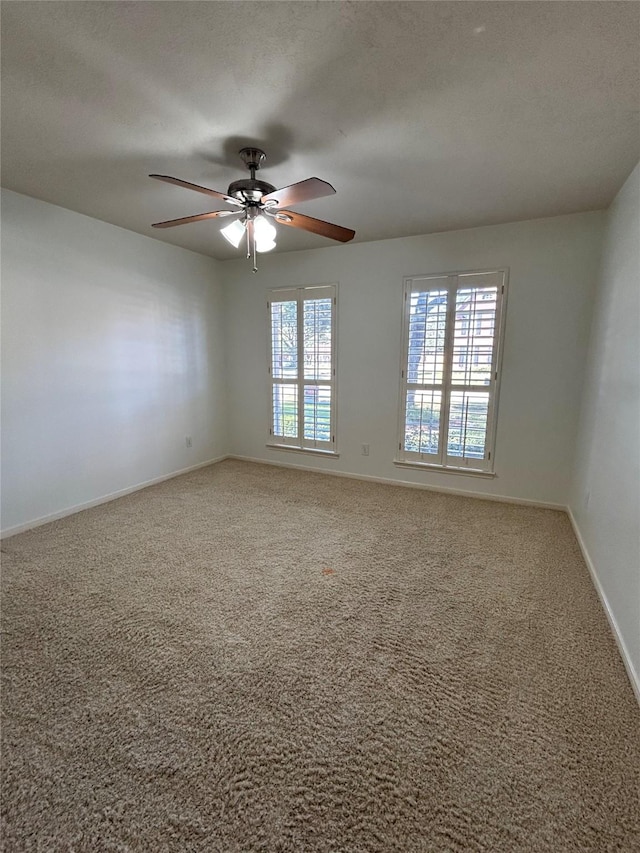 spare room with ceiling fan, carpet floors, and a textured ceiling