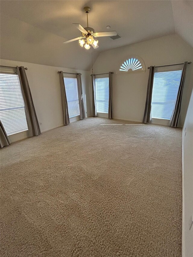 carpeted empty room with ceiling fan and vaulted ceiling