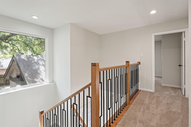 corridor with light colored carpet