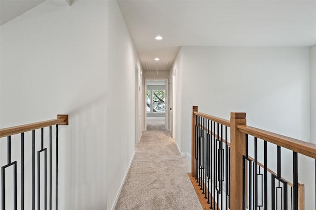 hallway with light colored carpet