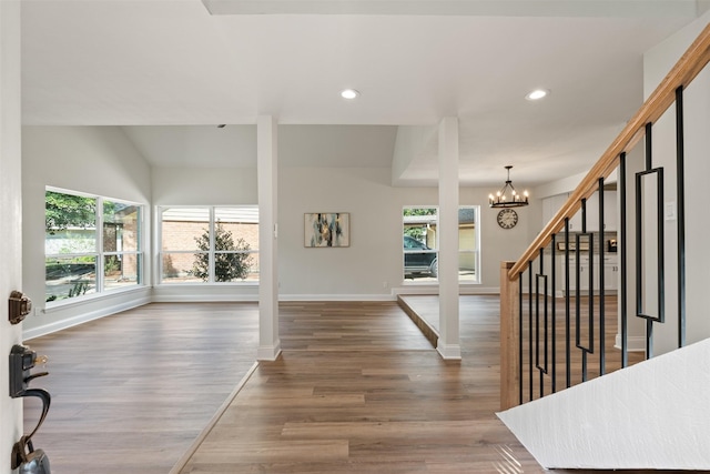 foyer entrance with a chandelier and dark wood-type flooring