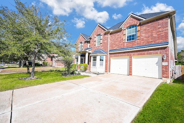 view of front of house featuring a garage and a front lawn