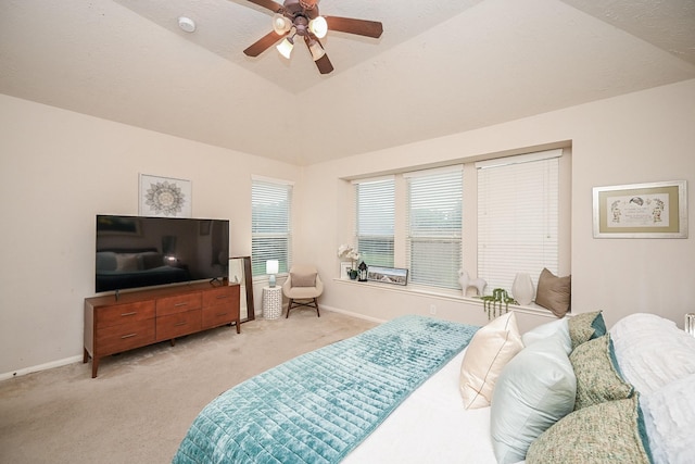 carpeted bedroom with ceiling fan and lofted ceiling