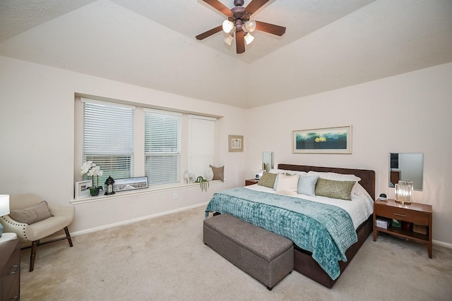 bedroom with a textured ceiling, a tray ceiling, vaulted ceiling, ceiling fan, and carpet floors