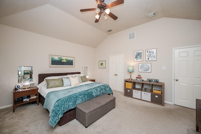 bedroom with ceiling fan, light carpet, and vaulted ceiling