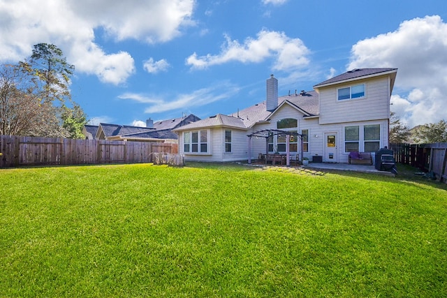 back of house featuring a pergola, a lawn, and a patio