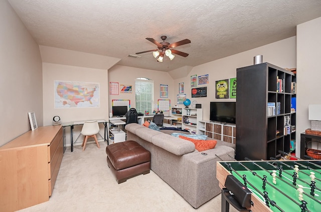 carpeted living room with ceiling fan and a textured ceiling