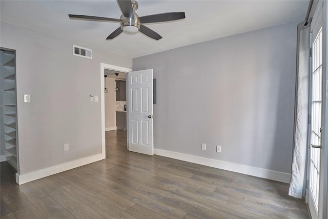 spare room with ceiling fan and dark hardwood / wood-style floors