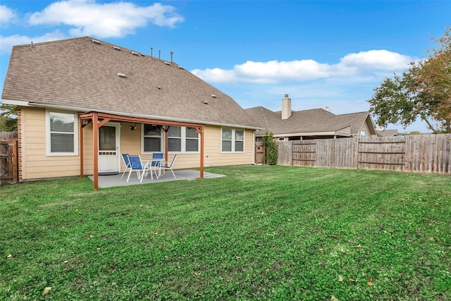 rear view of property featuring a patio area and a lawn