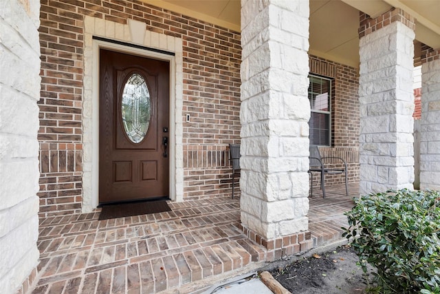 view of exterior entry with covered porch