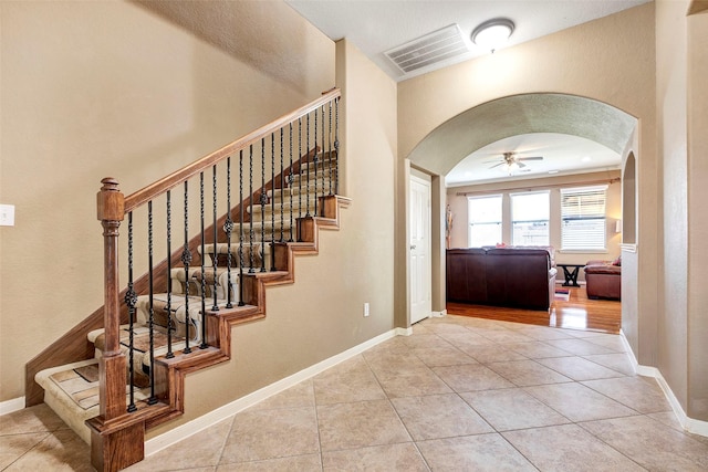 entryway with ceiling fan and light tile patterned flooring