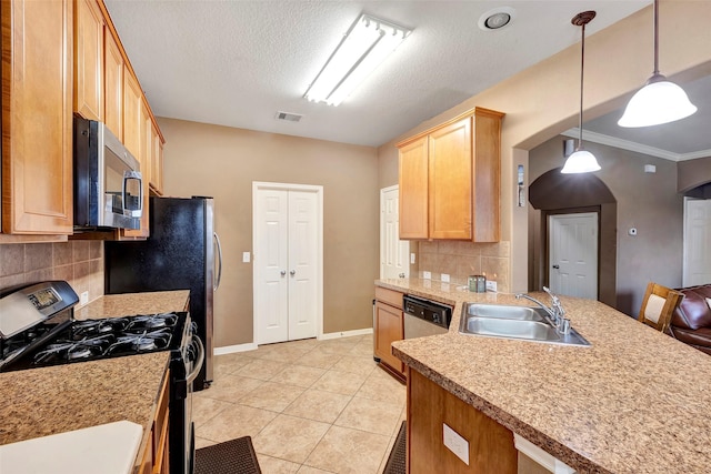 kitchen with backsplash, sink, light tile patterned floors, appliances with stainless steel finishes, and decorative light fixtures