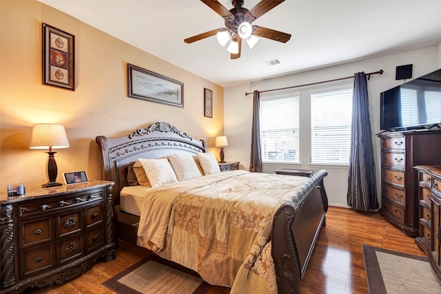 bedroom with hardwood / wood-style floors and ceiling fan