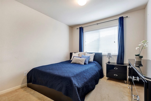 bedroom featuring light carpet