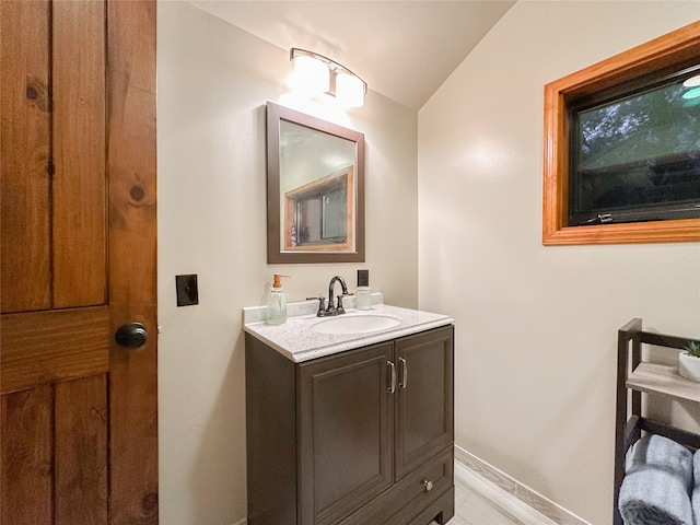 bathroom with vanity and vaulted ceiling