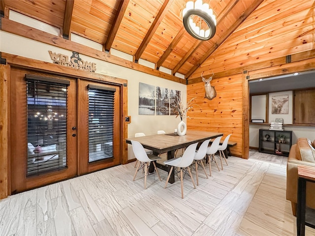 dining area featuring wood walls, high vaulted ceiling, french doors, beam ceiling, and wood ceiling